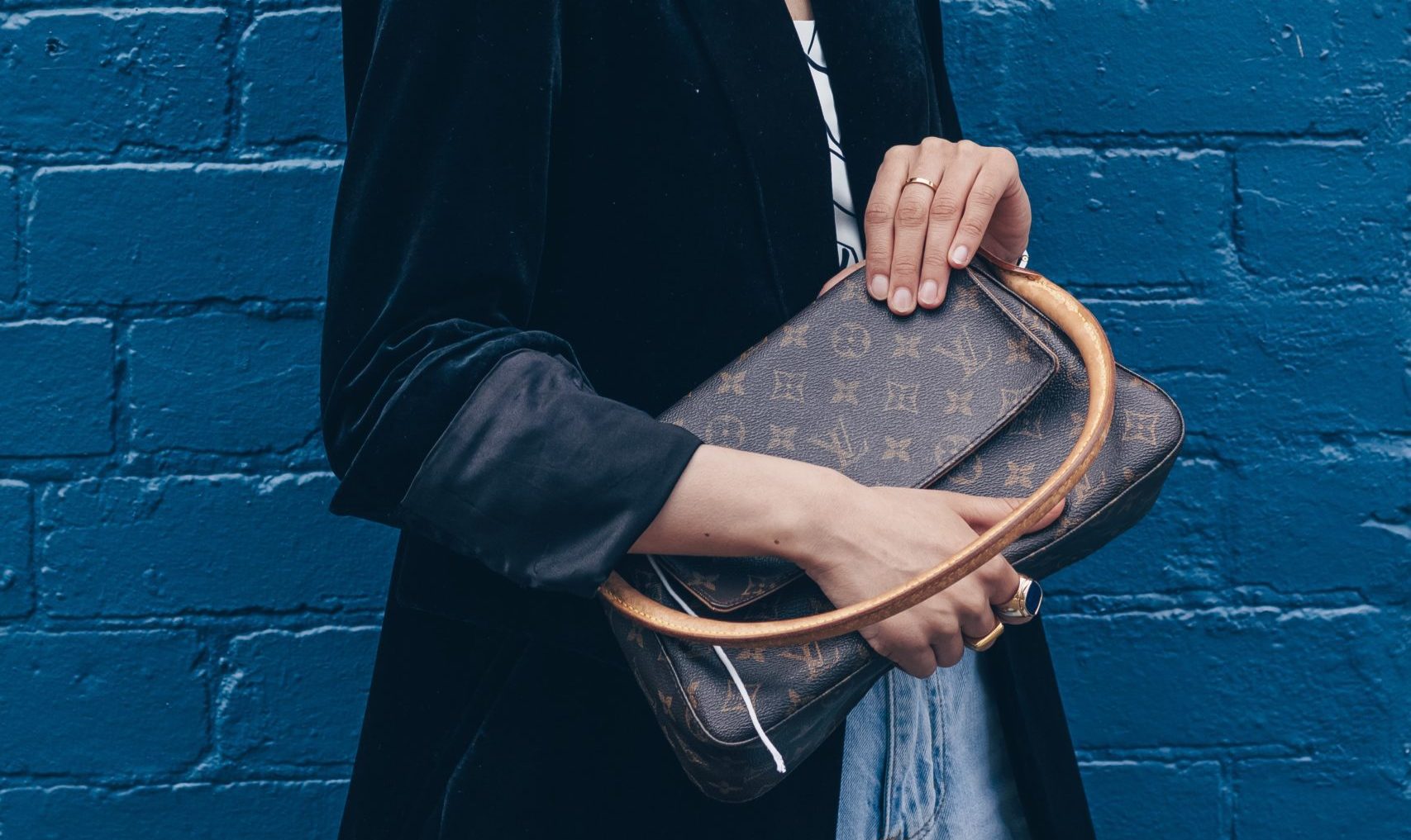 woman holding Louis Vuitton purse