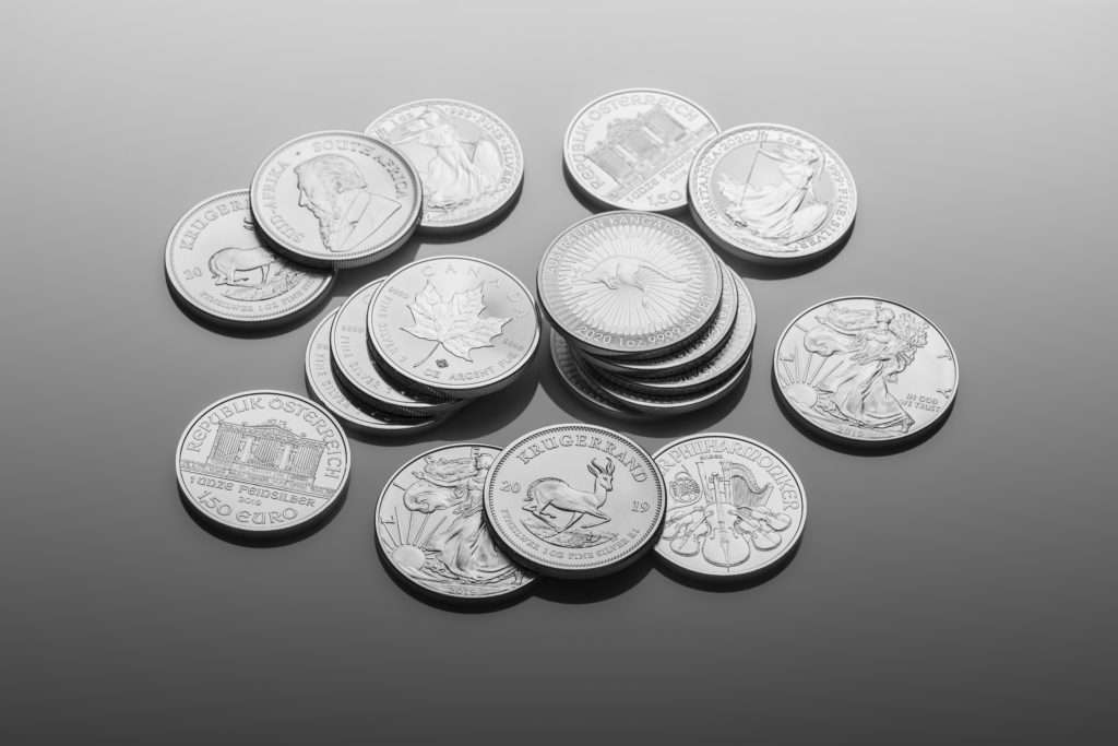 various silver coins on grey background